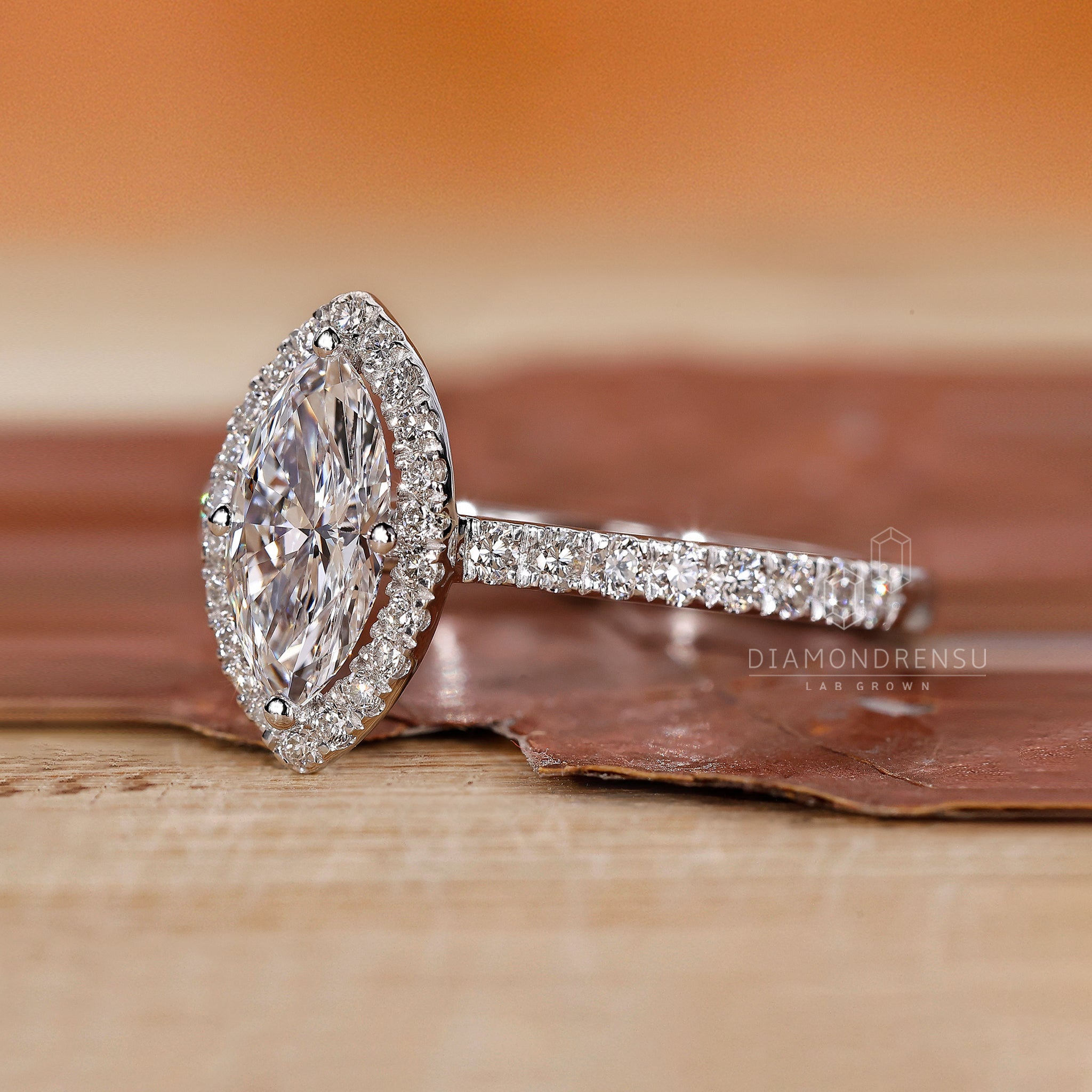 Halo engagement ring with marquise center stone.
