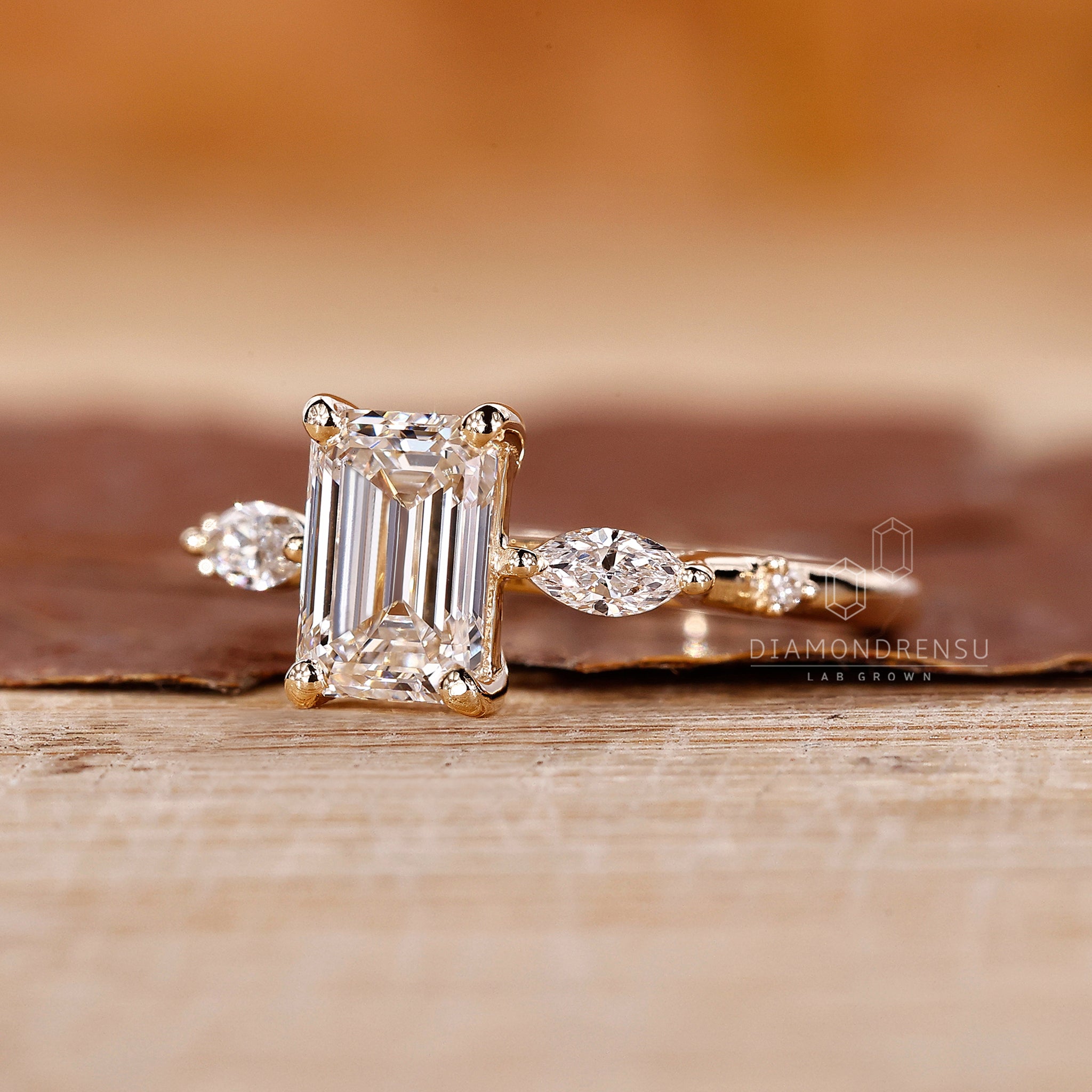 Proposal engagement ring in yellow gold with emerald diamond center.

