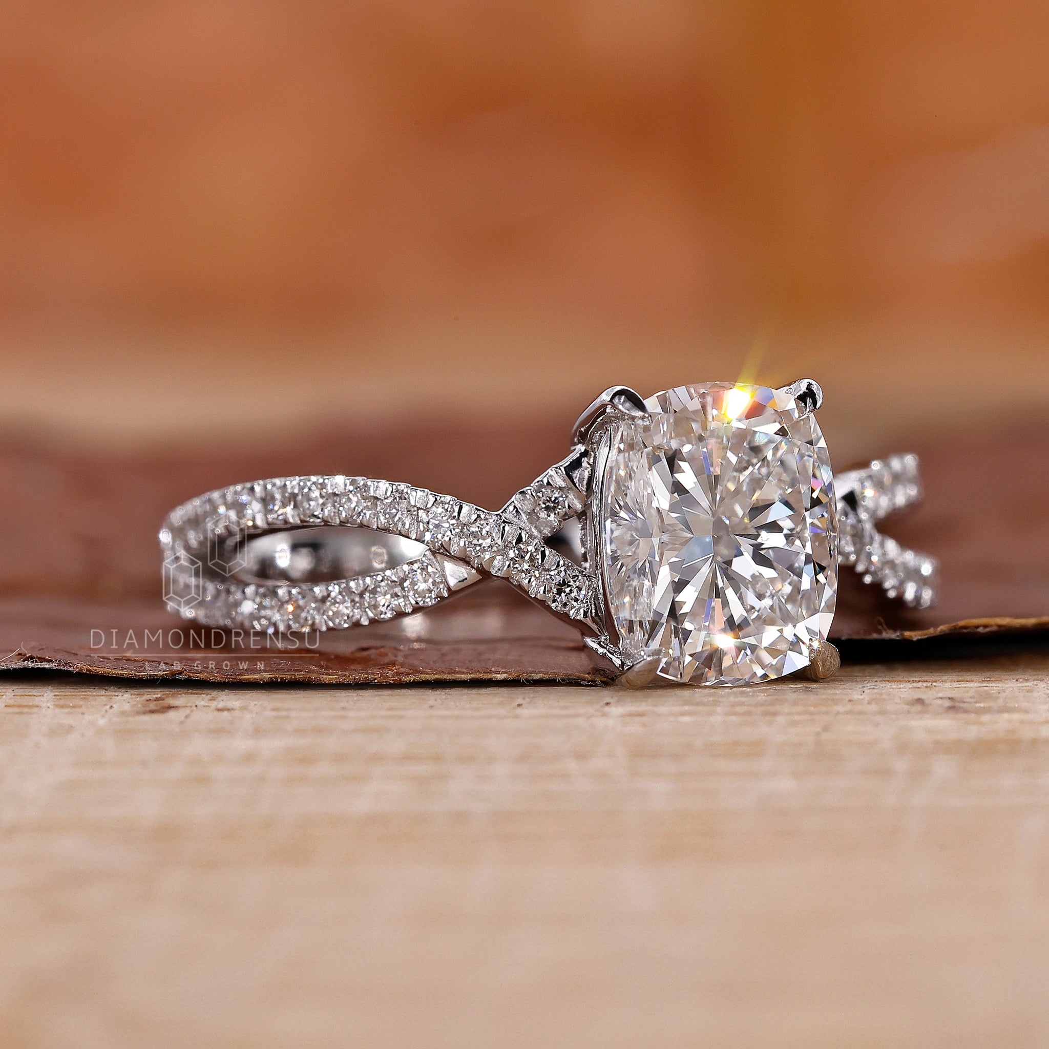 White gold ring with a 4 claw prong and cushion cut diamond.
