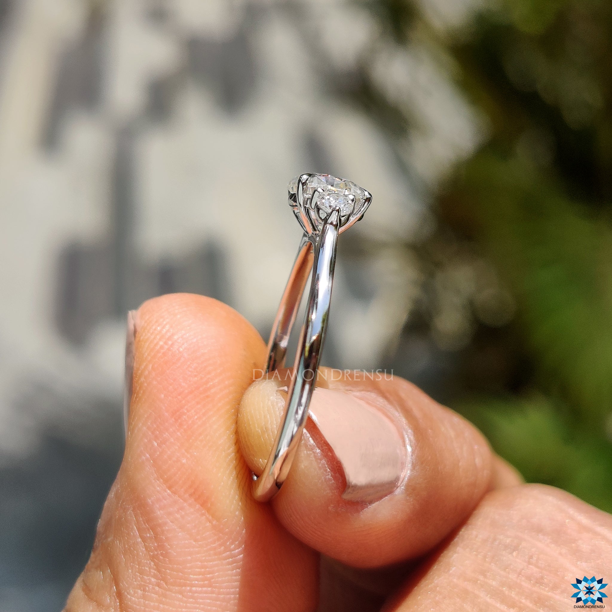 Buy engagement ring with three round cut moissanites in white gold.
