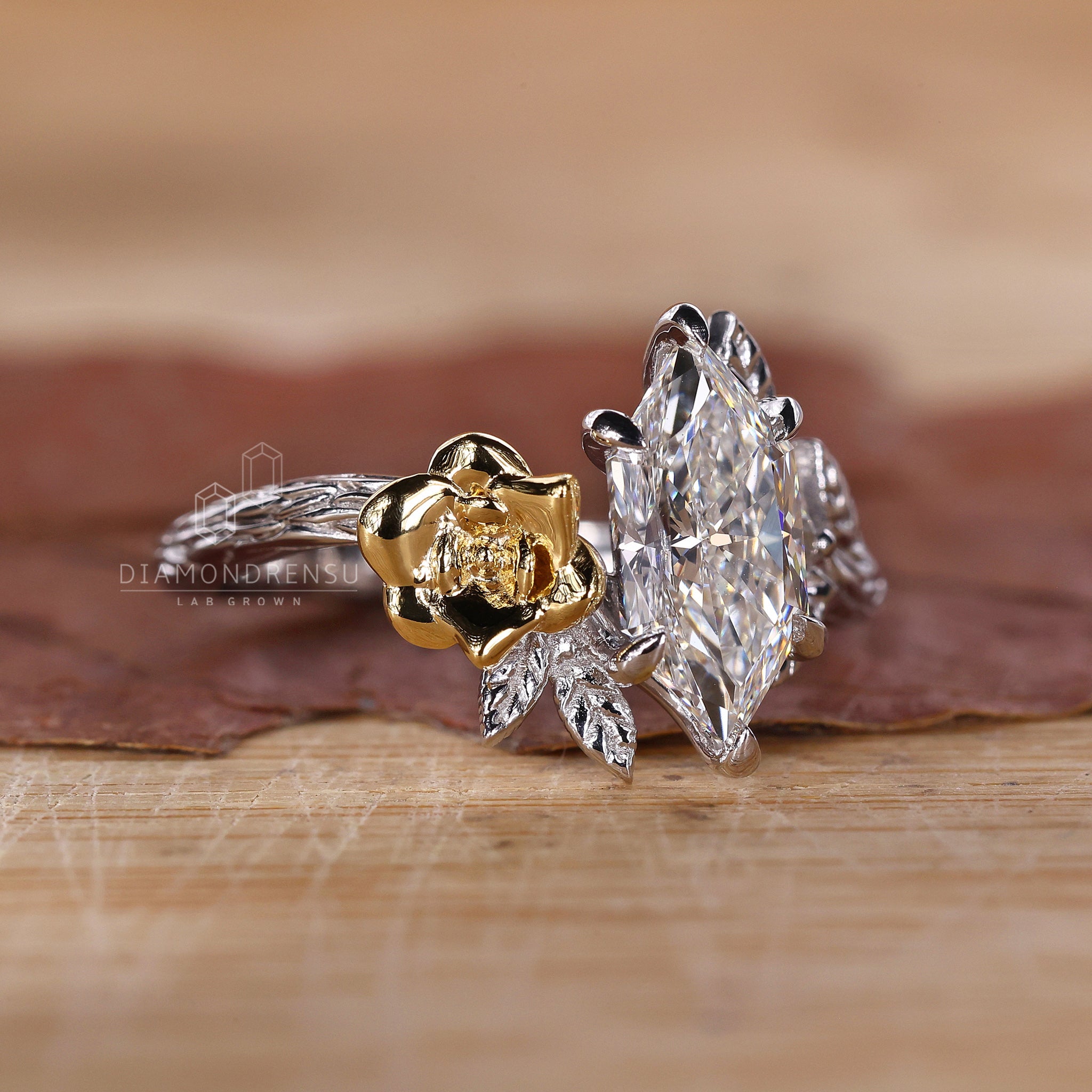 UK engagement ring featuring dutch marquise and round side diamond.
