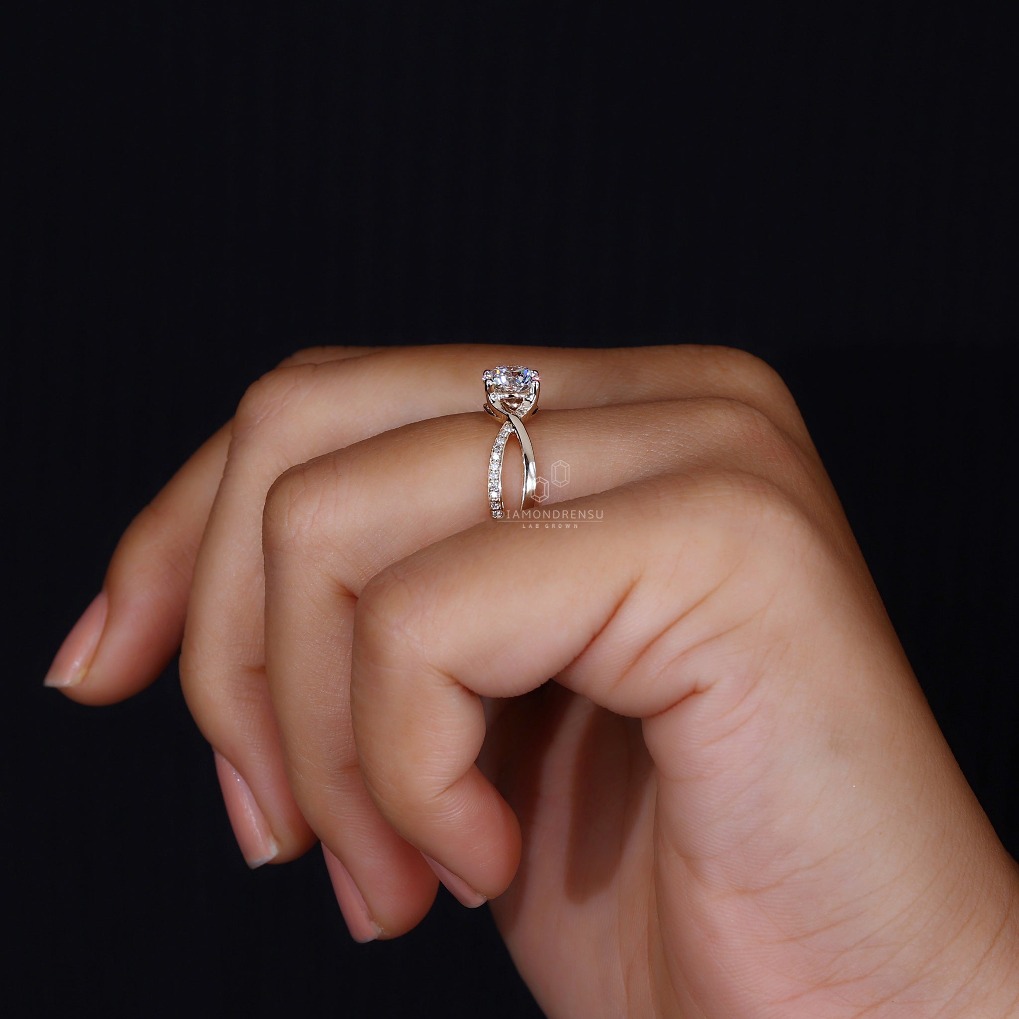 Twisted pave band with round center stone.
