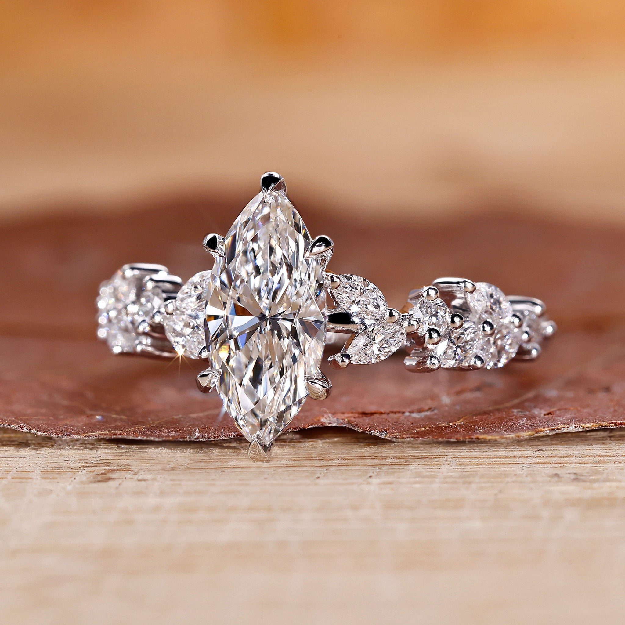 Custom engagement ring with marquise and round side diamond ring design.
