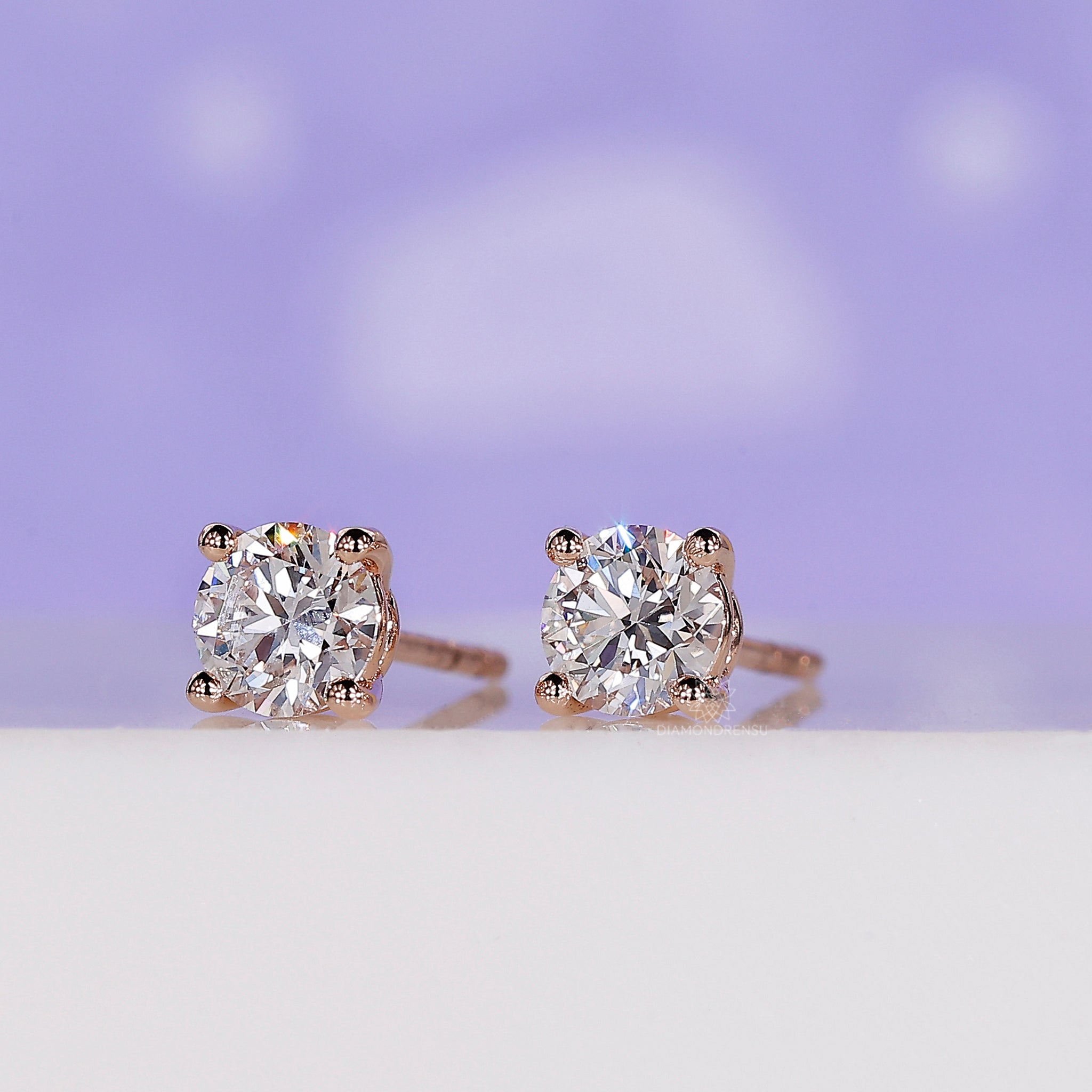 Handmade jewellery showcasing rose gold round diamond stud earrings.