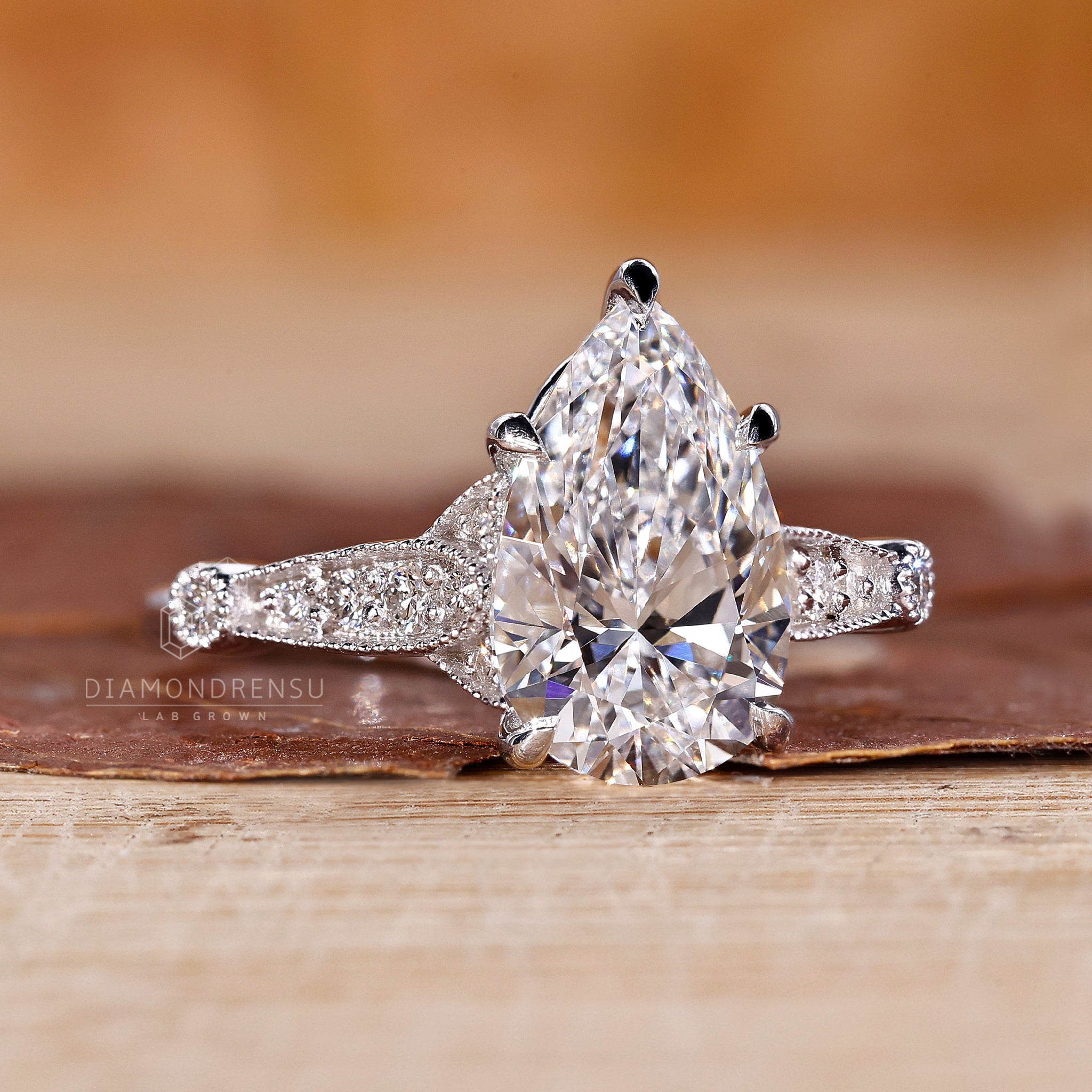 Proposal engagement ring with pear diamond and perong setting design.
