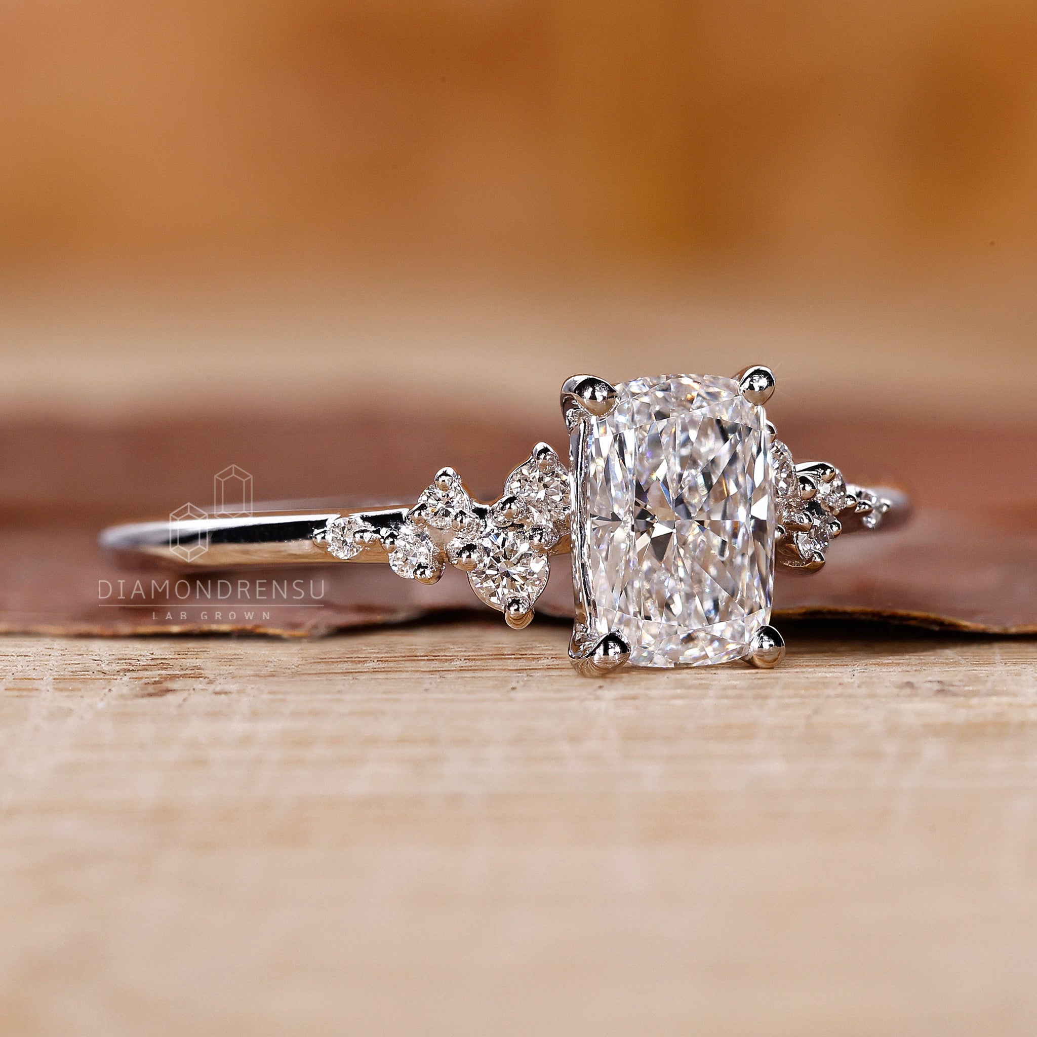 Prong setting ring with round side stones and handmade finish.
