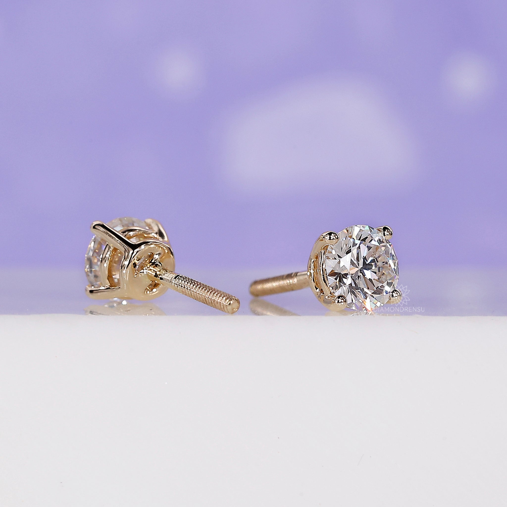 Elegant yellow gold handmade earrings set with round diamond studs.
