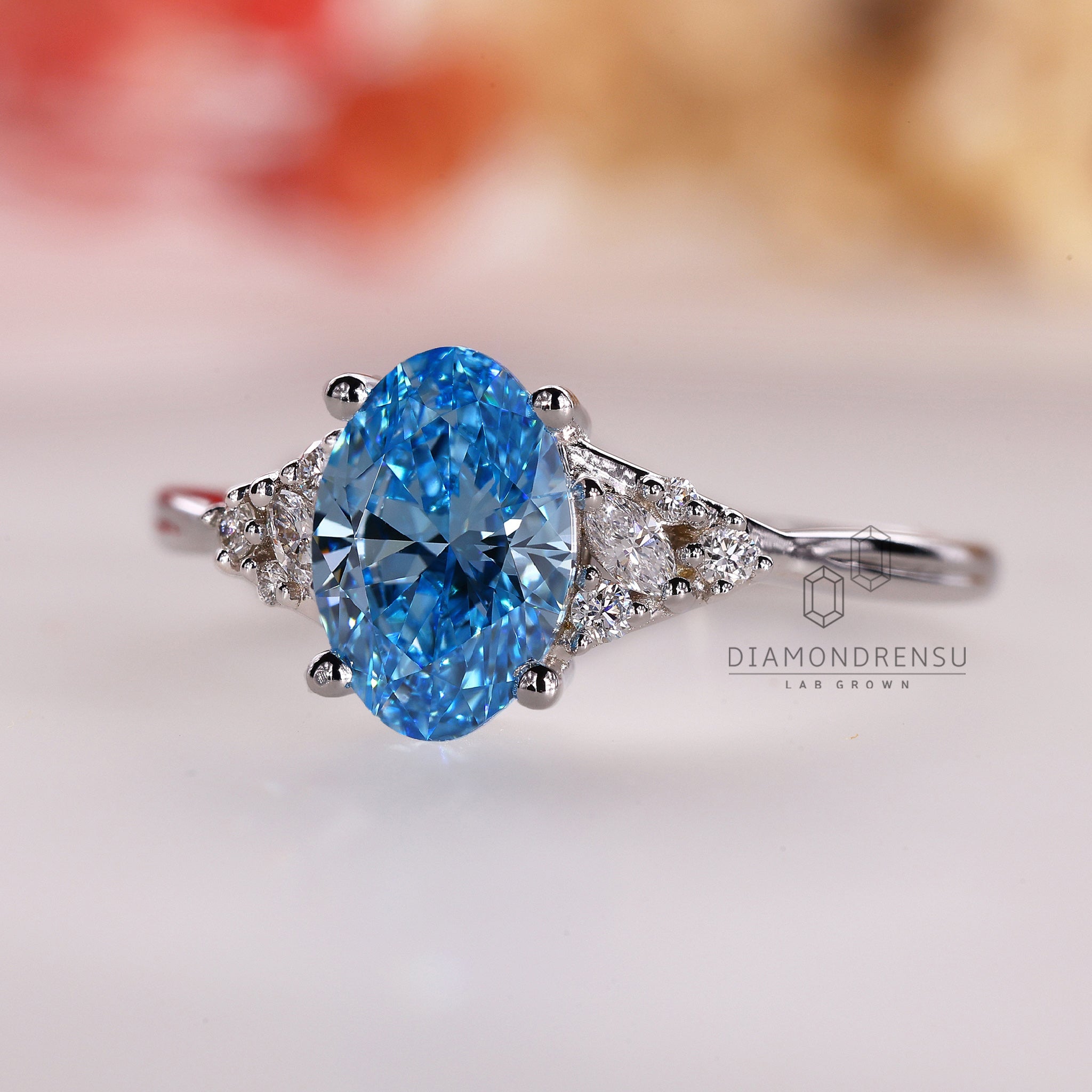 Custom engagement ring with prong set blue oval diamond for UK buyers.
