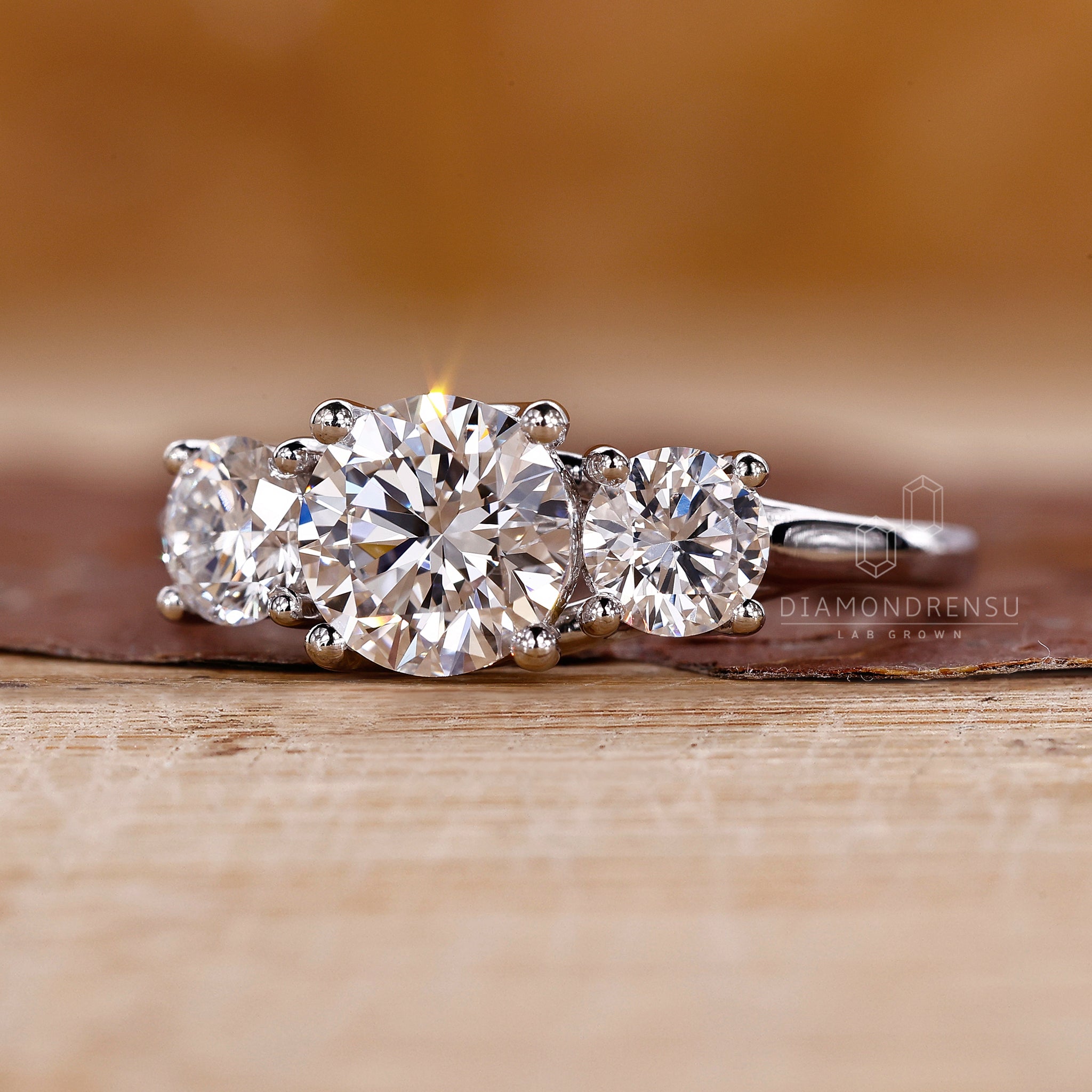 Buy engagement ring online with three stone round diamond style.
