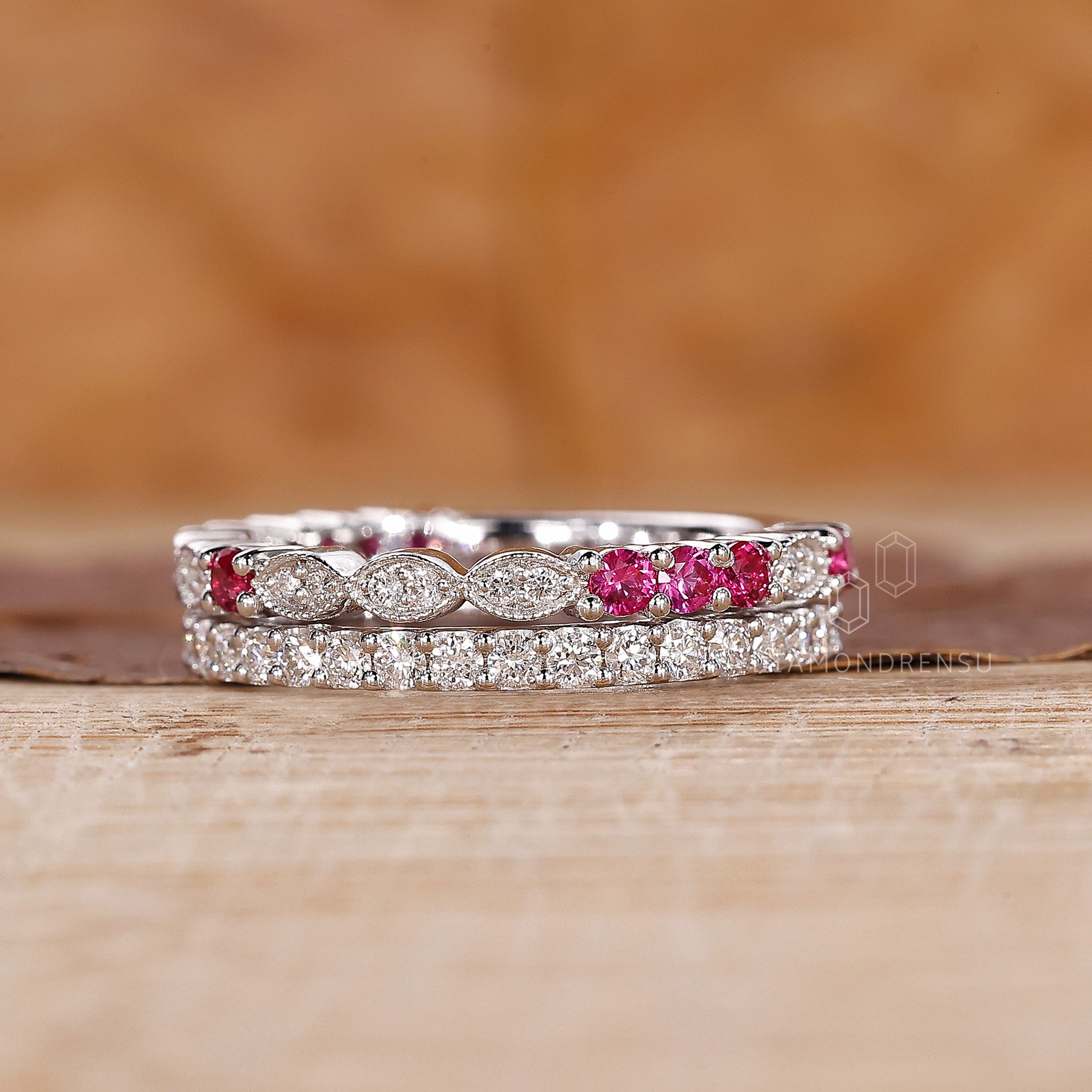 Marquise shape outline band with ruby and diamond accents.