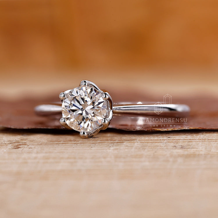 Custom diamond ring with prong setting and tulip style detail.
