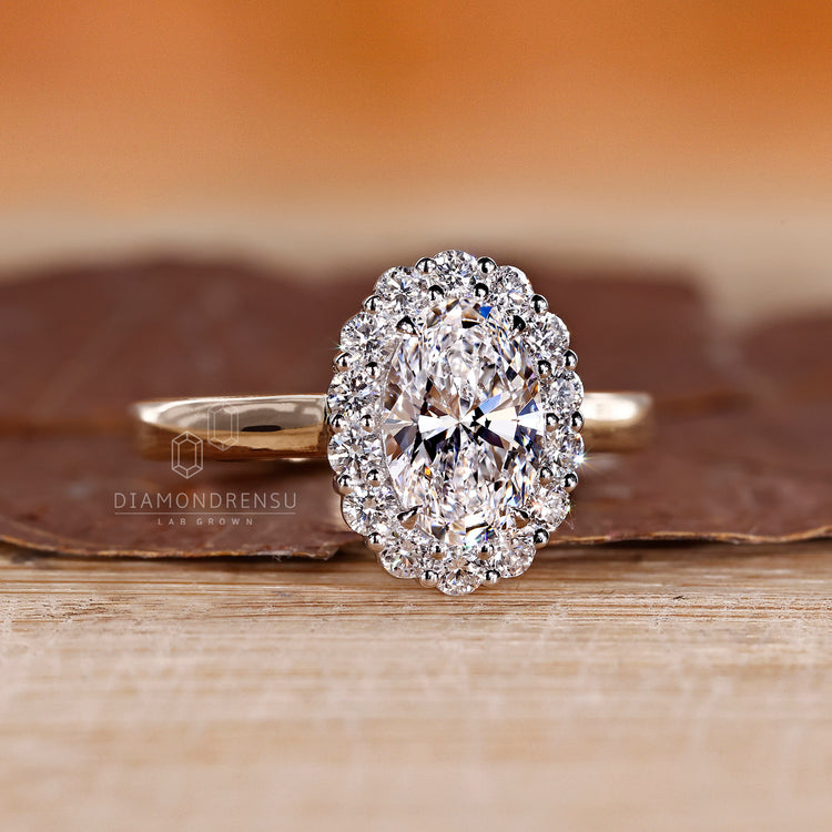 4 claw prong ring with oval and round cut diamonds.
