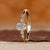Emerald cut gold ring with round side stones.

