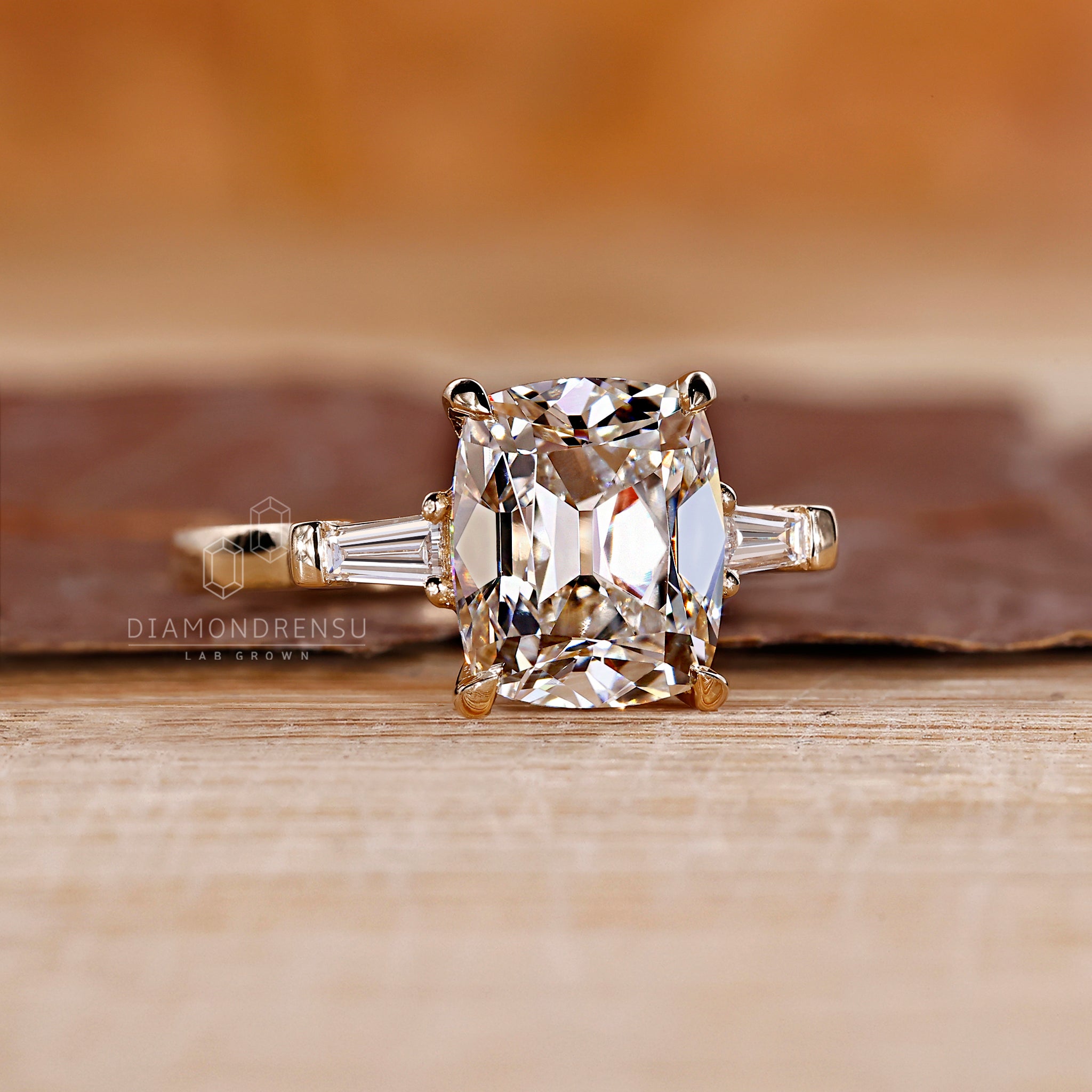 Yellow gold ring with cushion cut center diamond.
