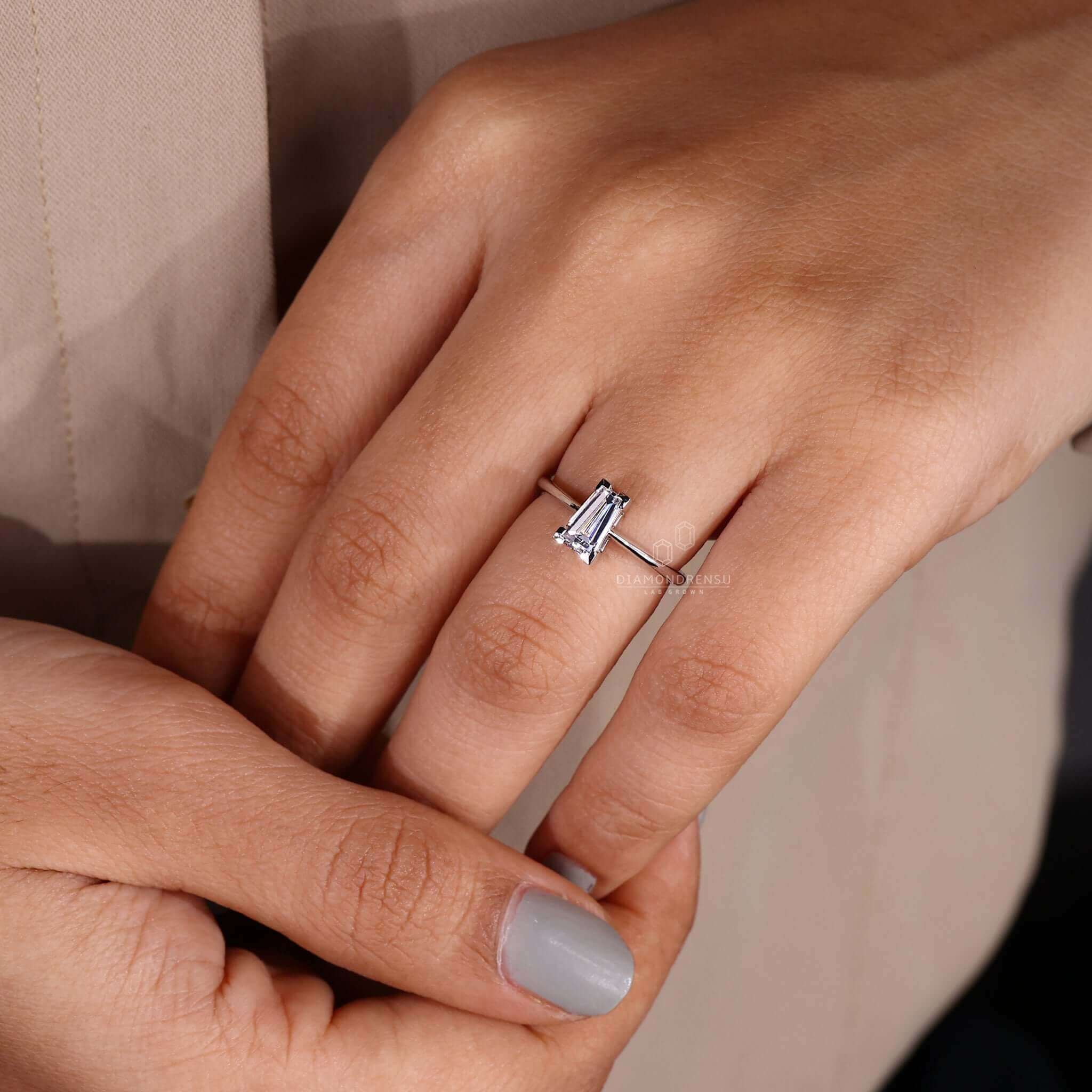 Model showcasing a tapered baguette engagement ring