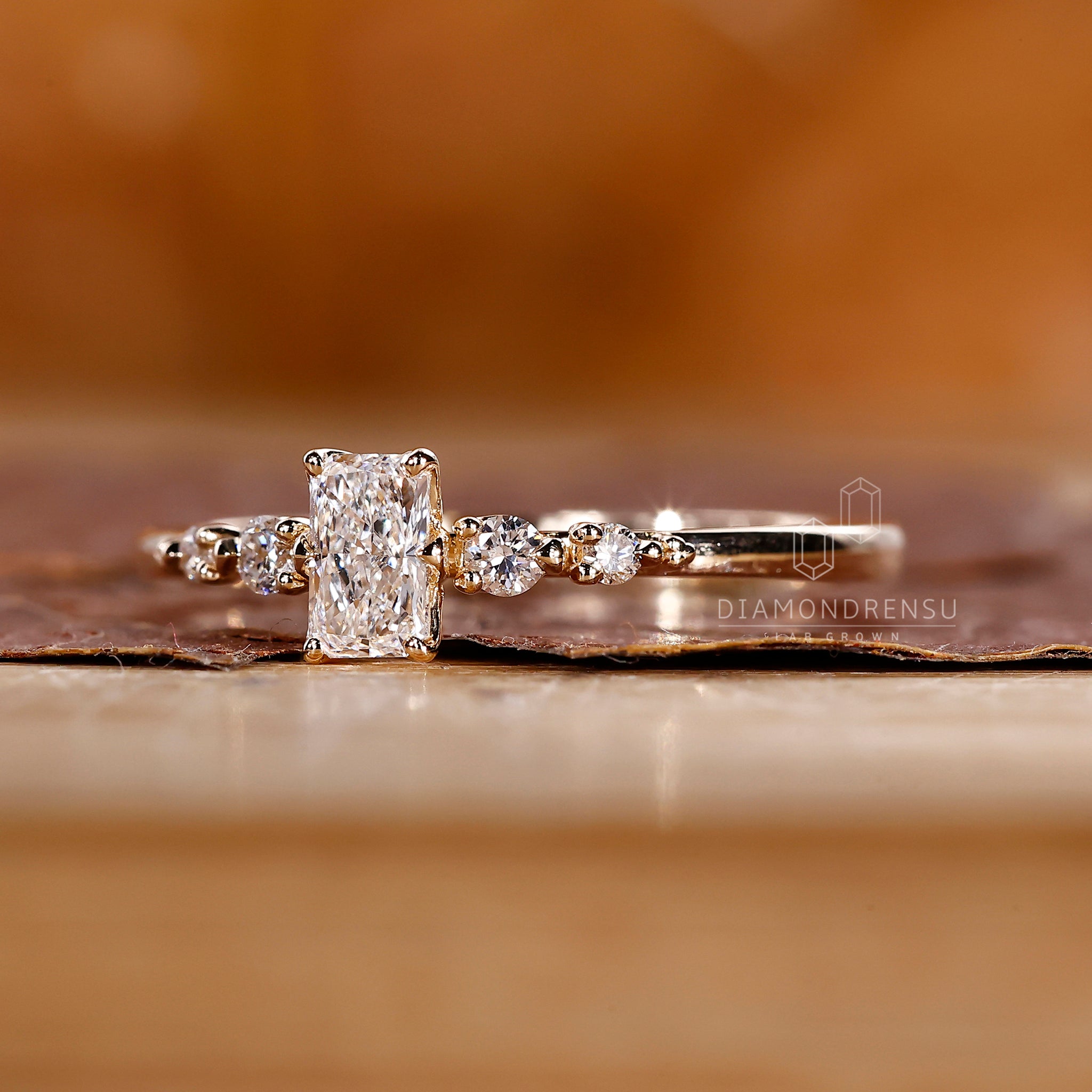 Buy diamond ring with radiant and round stones.
