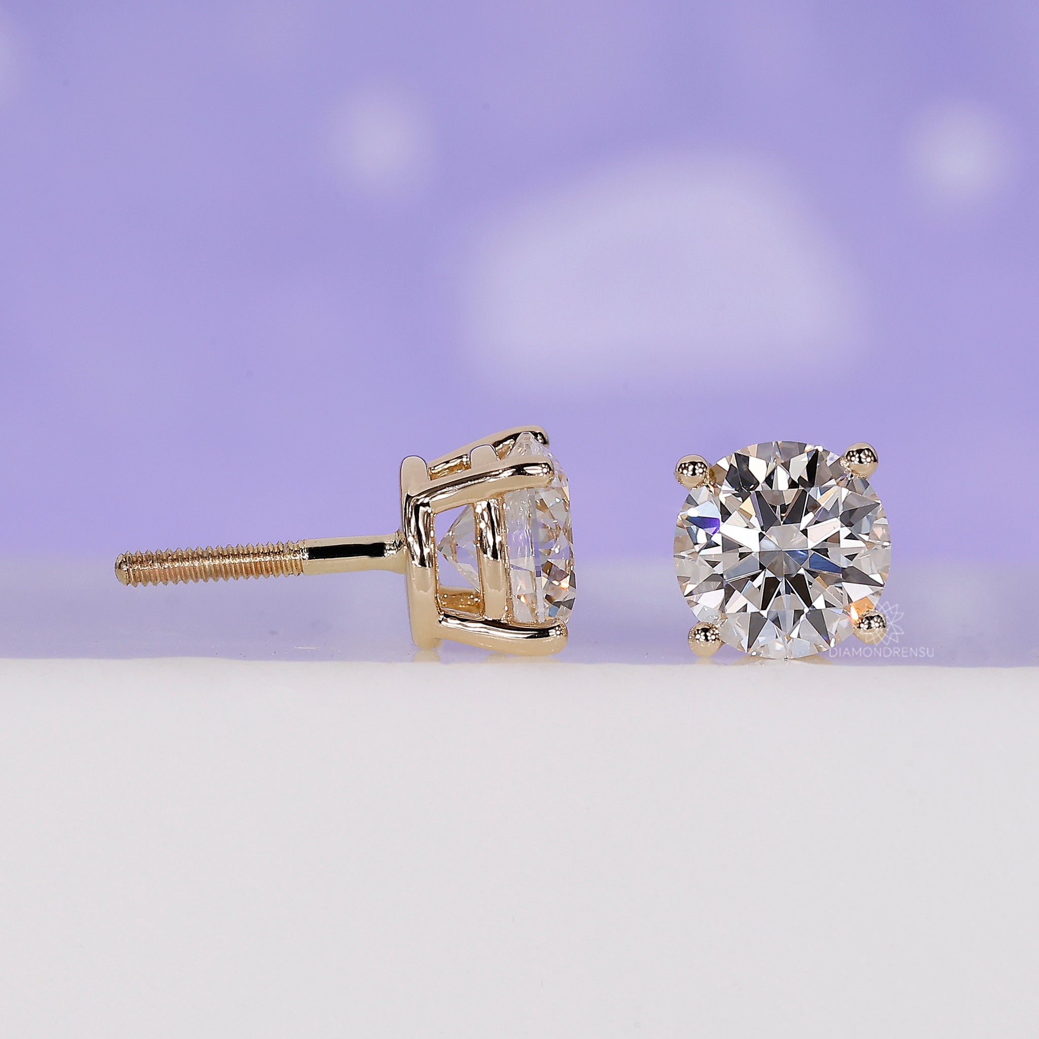 Custom diamond earrings designed as yellow gold round studs.