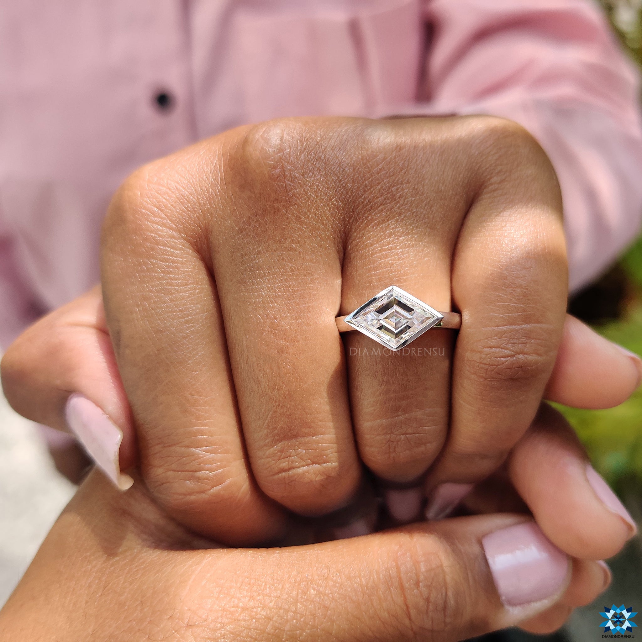 Handmade white gold engagement ring with lozenge cut stone.
