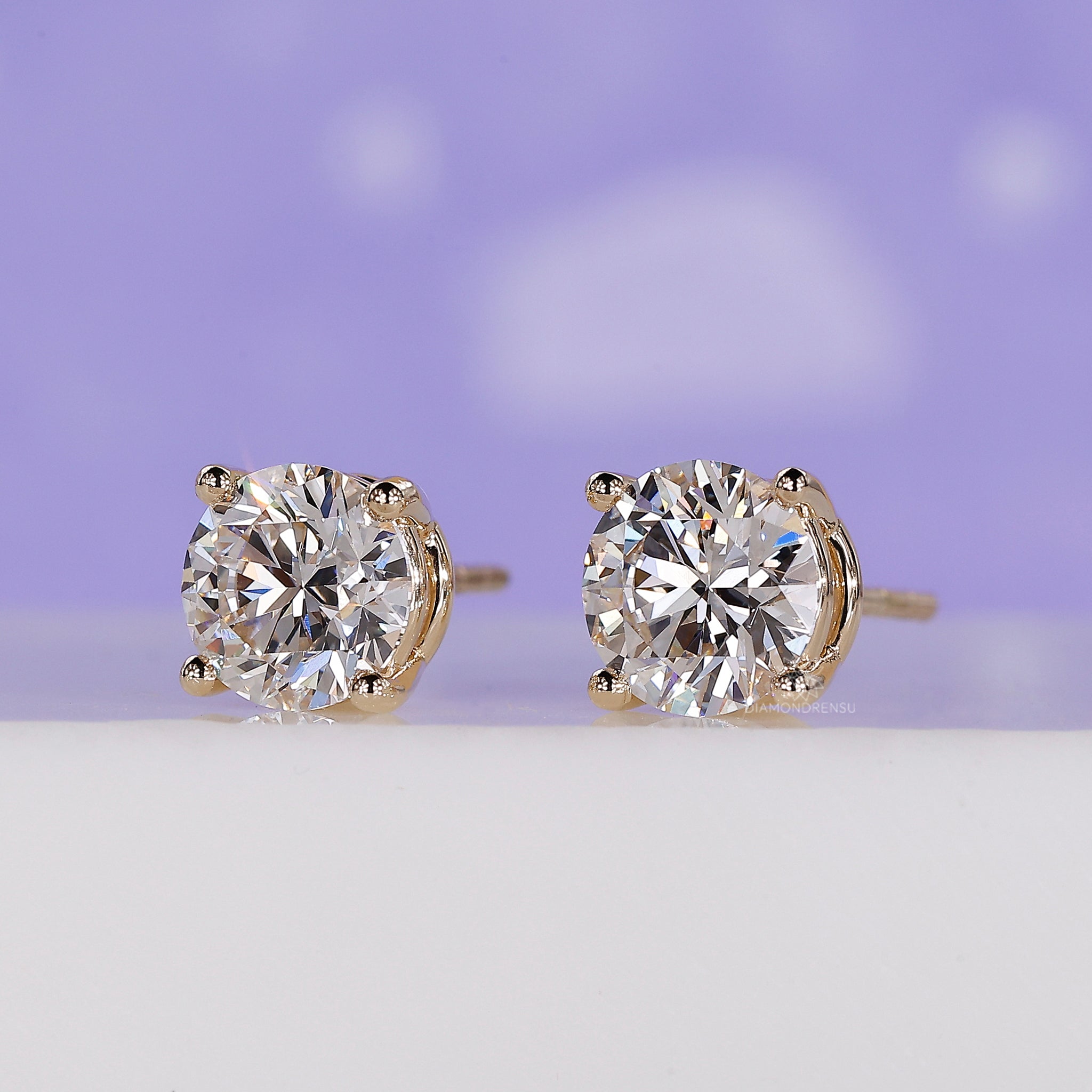 Simple gold earrings with round diamonds.