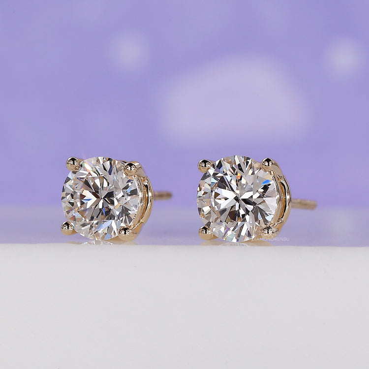 Simple gold earrings with round diamonds.