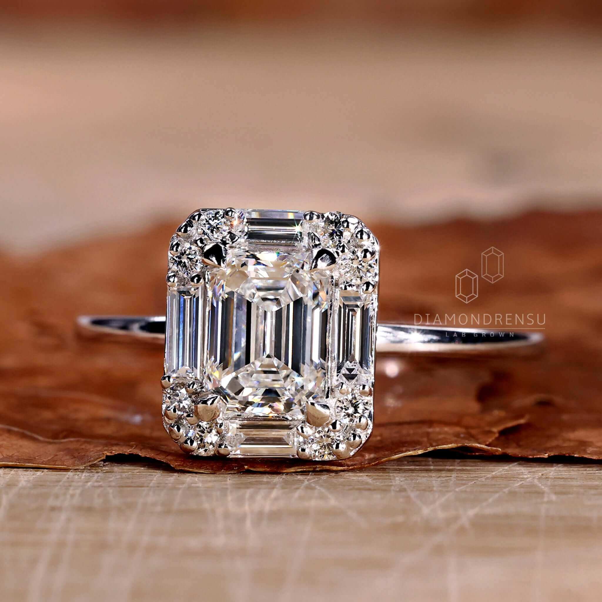 White gold engagement ring featuring a baguette diamond ring with Lab Grown Diamond accents for sustainable elegance.