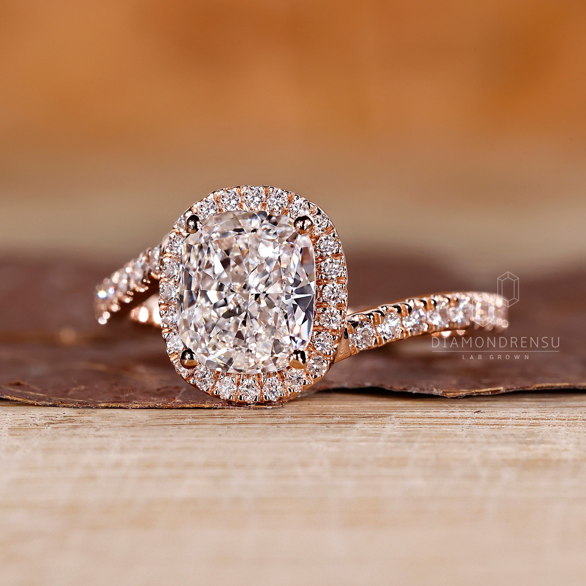 Round cut halo diamond set in a bypass ring.
