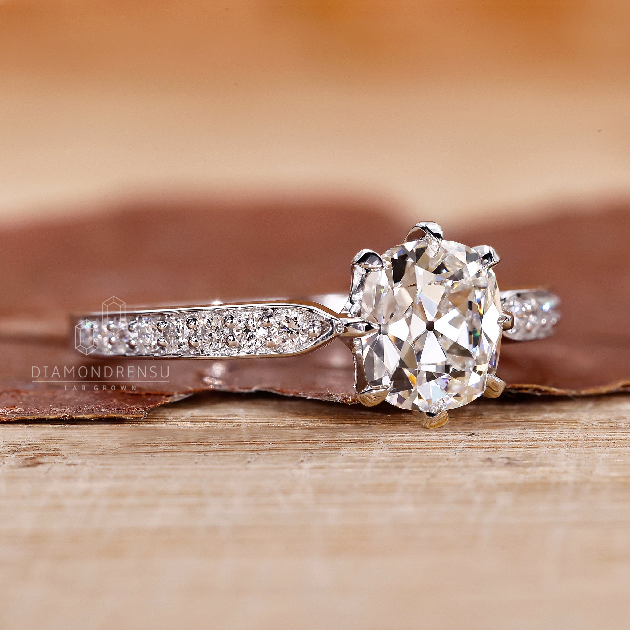 UK engagement ring featuring old mine cut cushion and prong ring setting.
