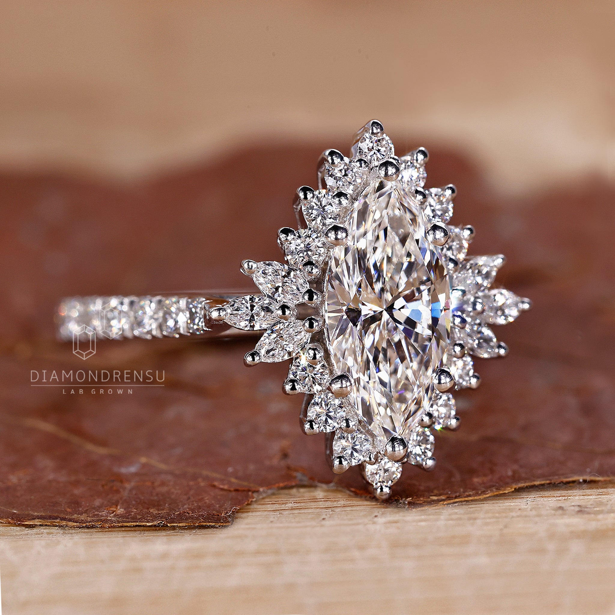 White gold ring with prong setting and round cut halo details.
