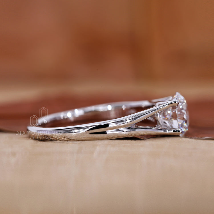 Handmade ring with split shank and round diamond details.
