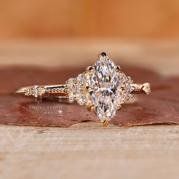 Gift for her with marquise cluster and round side stones.

