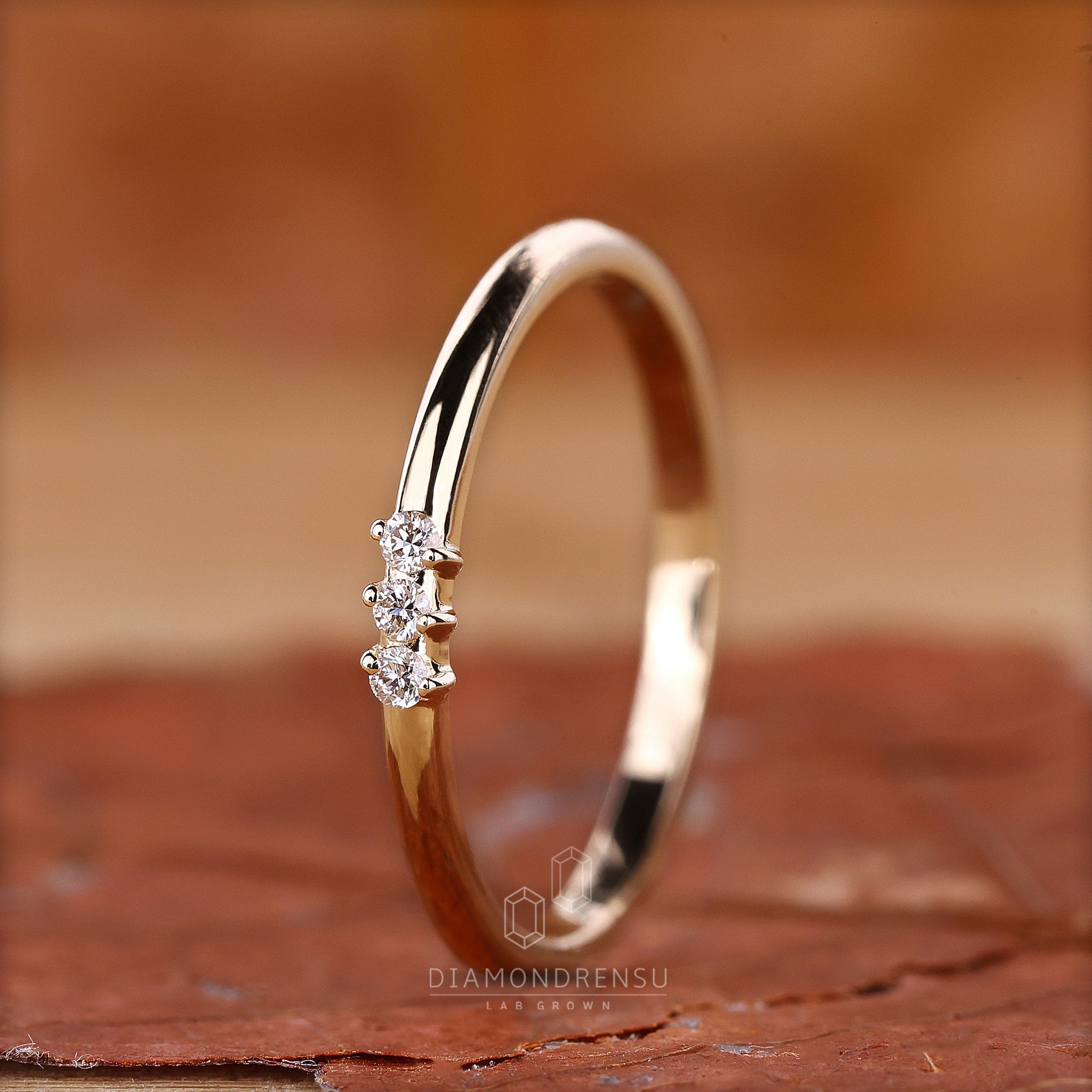 Unique three stone diamond band in gold.
