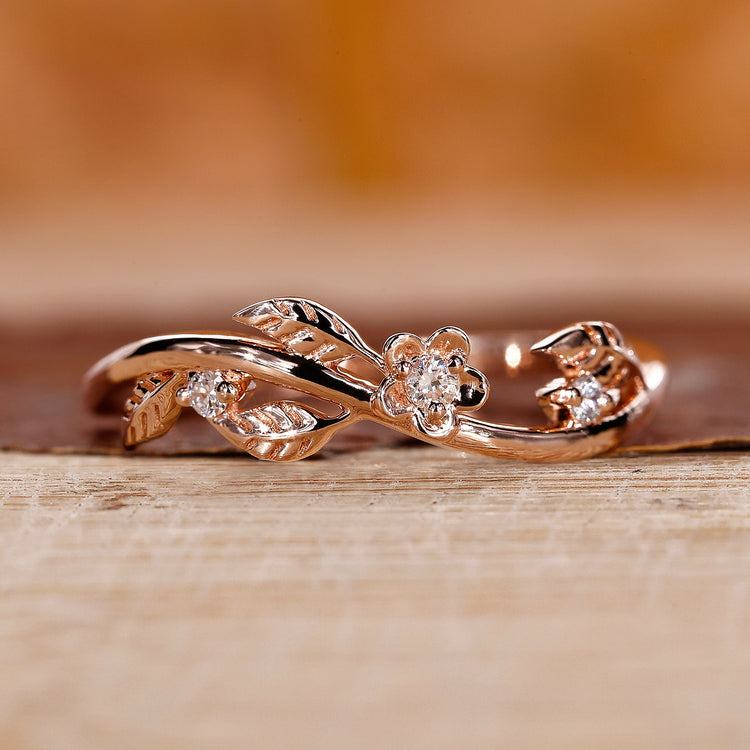Nature inspired wedding band with leaf detailing and round cut diamonds.