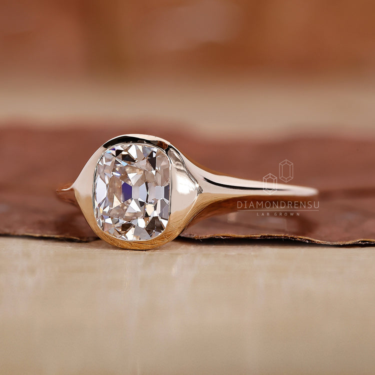 Bezel set engagement ring paired with tapered shank ring.

