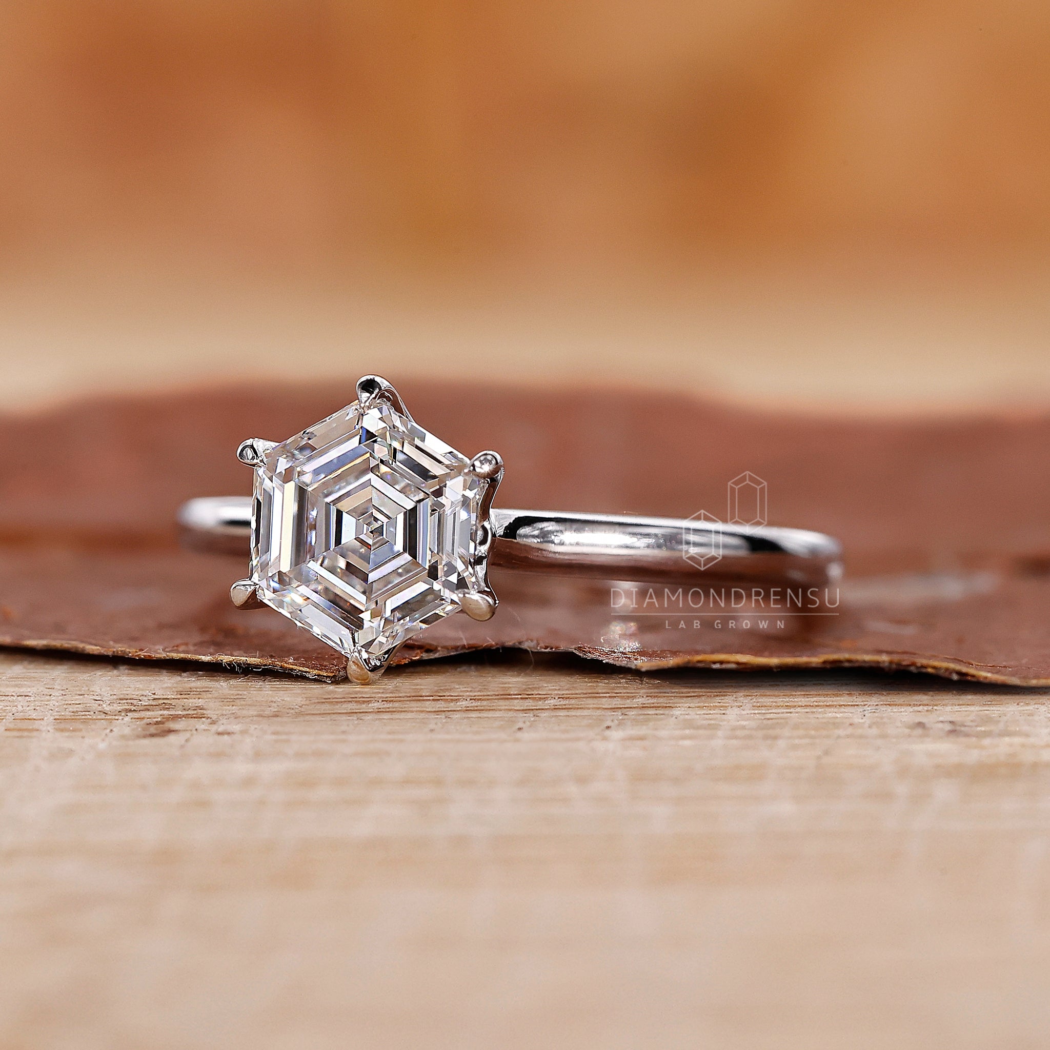 White gold diamond ring with a hexagon solitaire centre.
