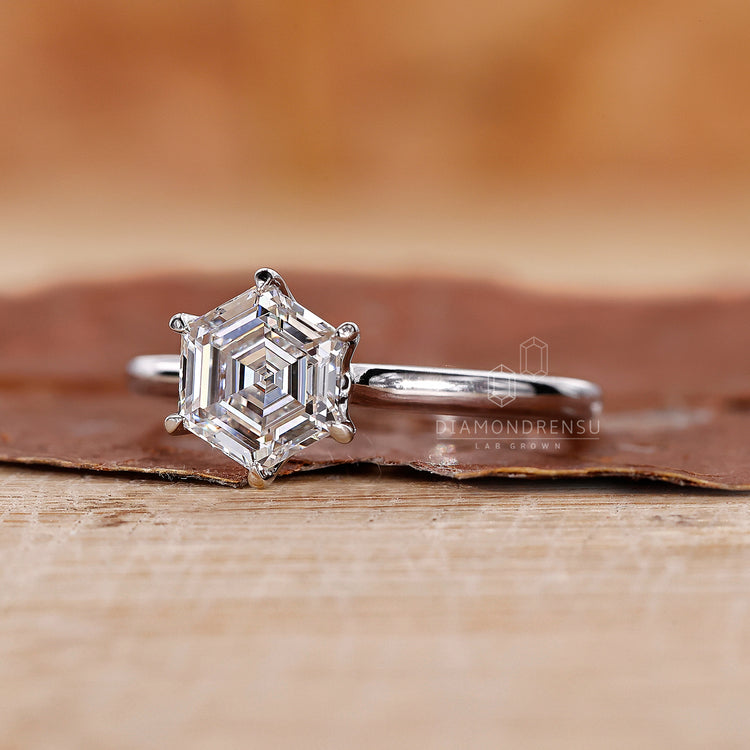 White gold diamond ring with a hexagon solitaire centre.
