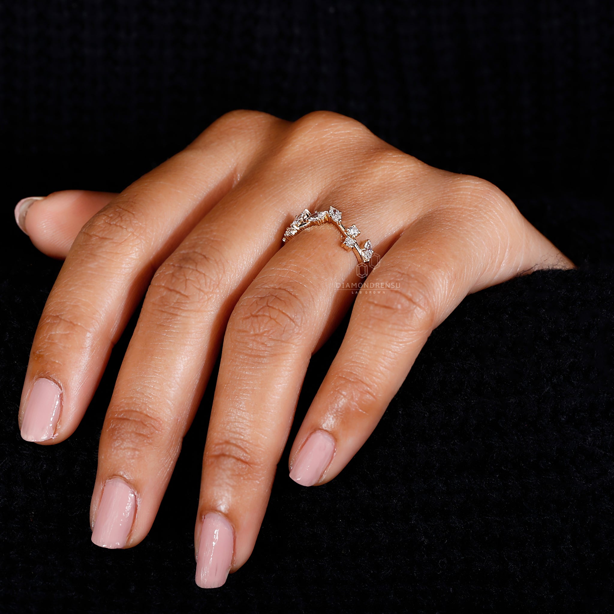 Model wearing a gold wedding band with nature-inspired design and lab-grown diamonds