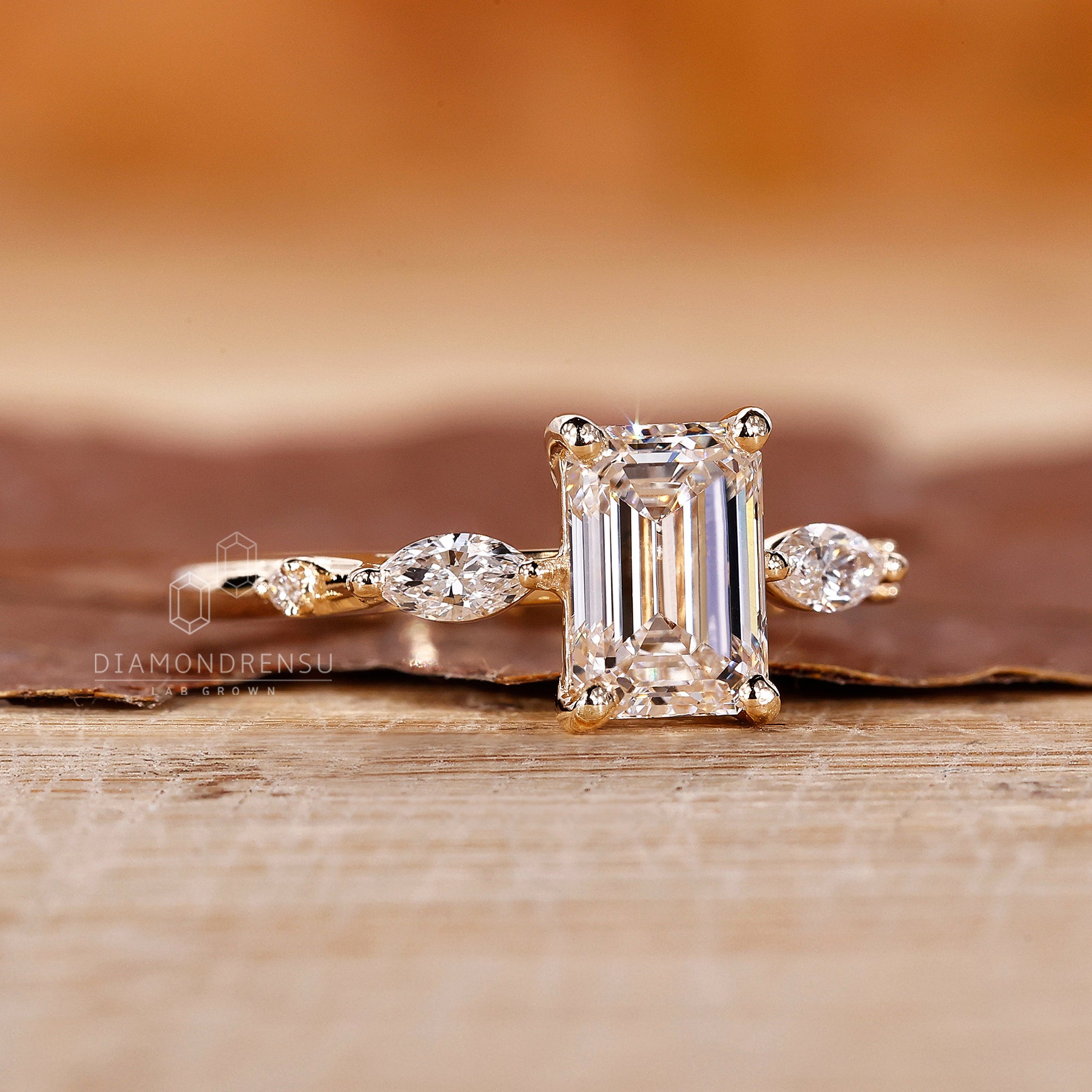 Diamondrensu UK engagement ring with lab diamond emerald center stone.
