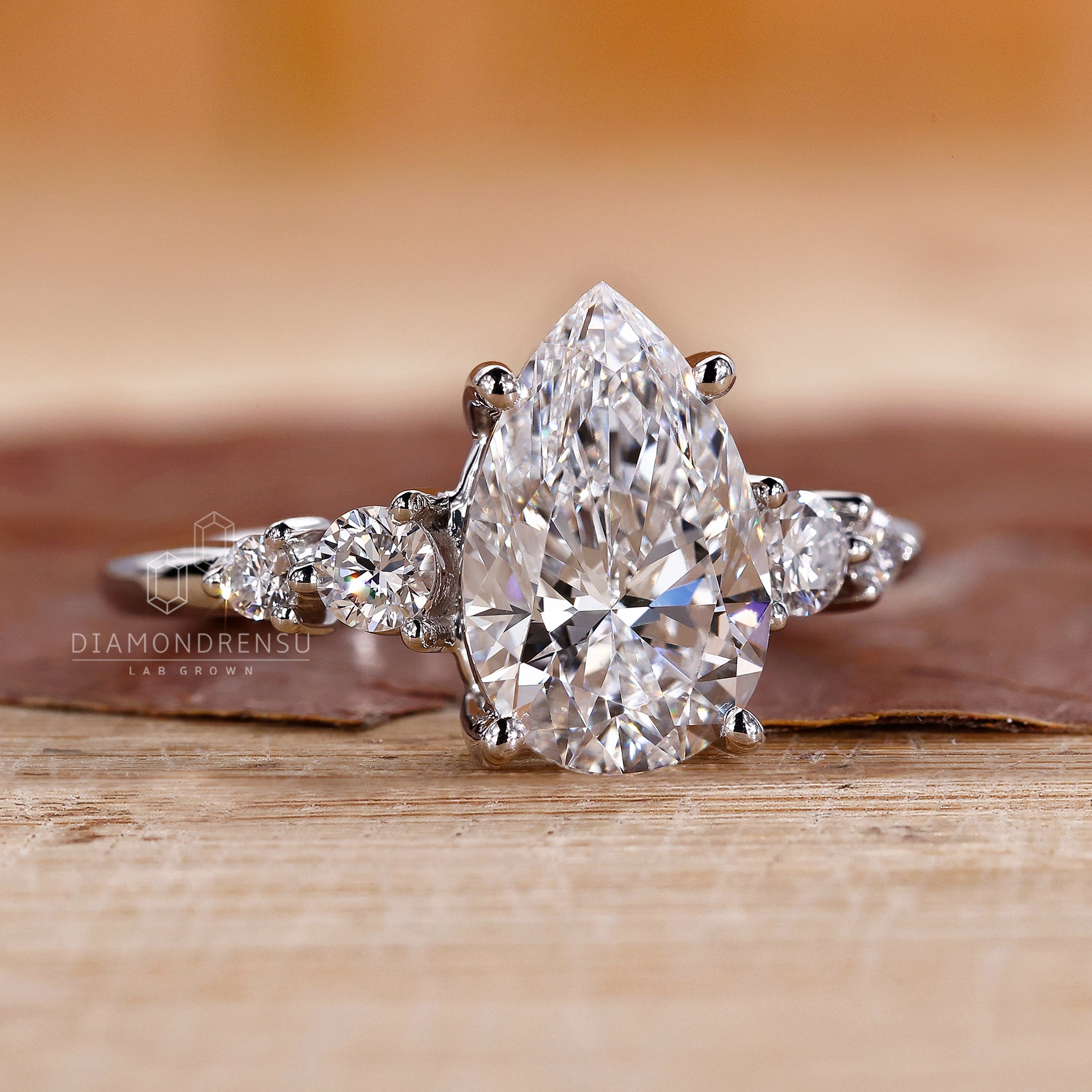 Custom diamond ring with prong setting and pear cut centre stone.
