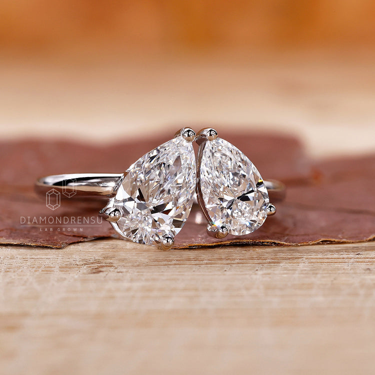 Diamondrensu UK engagement ring with two pear diamonds and three prong set.
