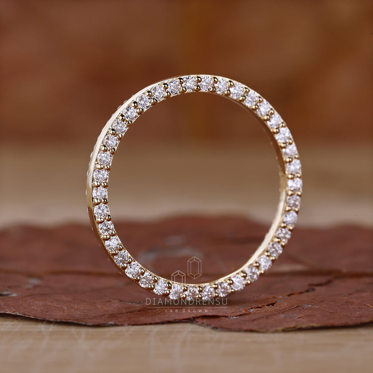 Yellow gold eternity wedding band with diamonds.
