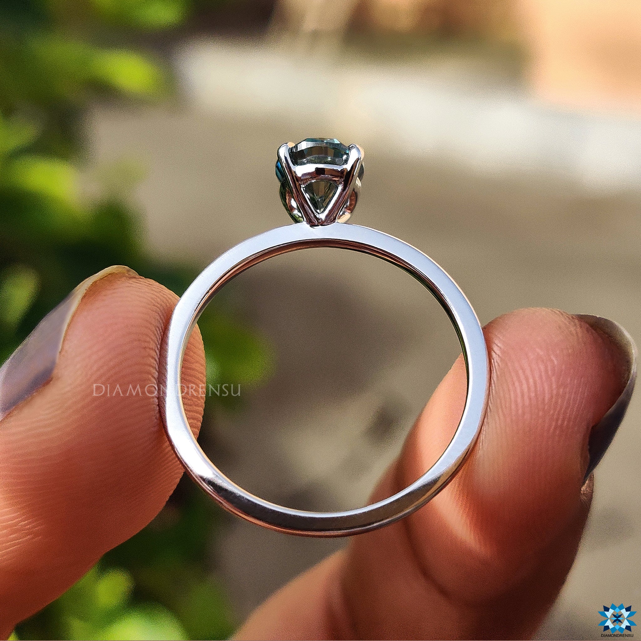 Cyan blue moissanite ring in oval engagement ring setting
