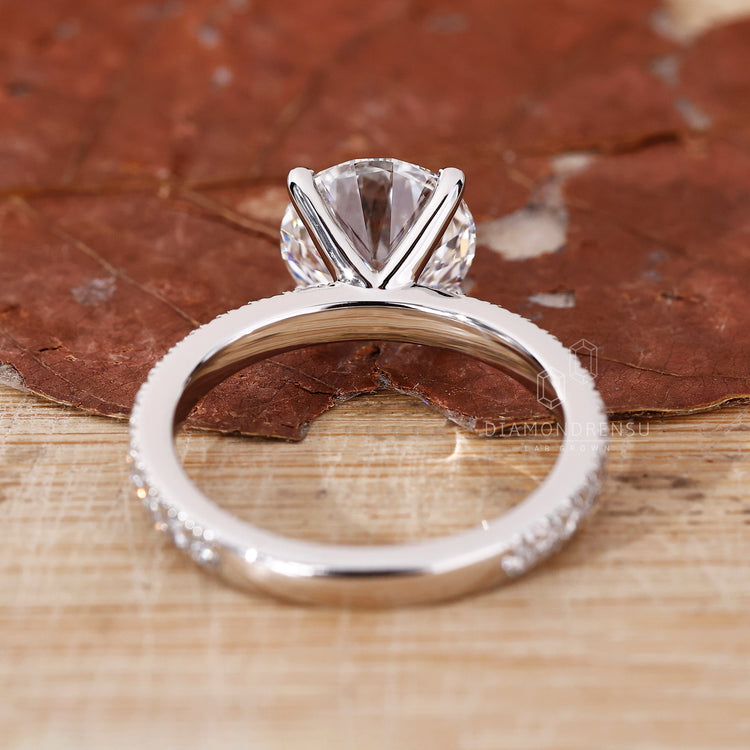 Lab grown round diamond in a white gold pavé band.
