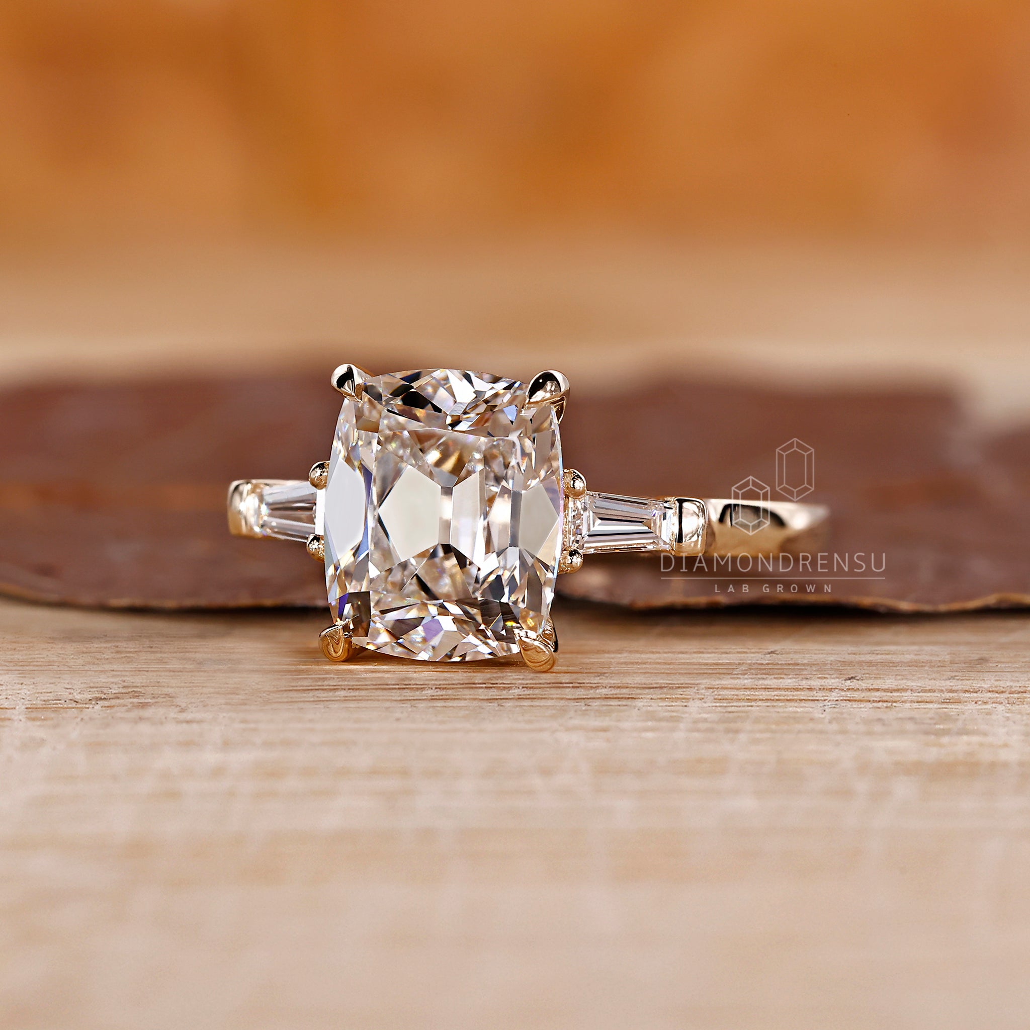 4 claw prong ring featuring a cushion old mine cut.
