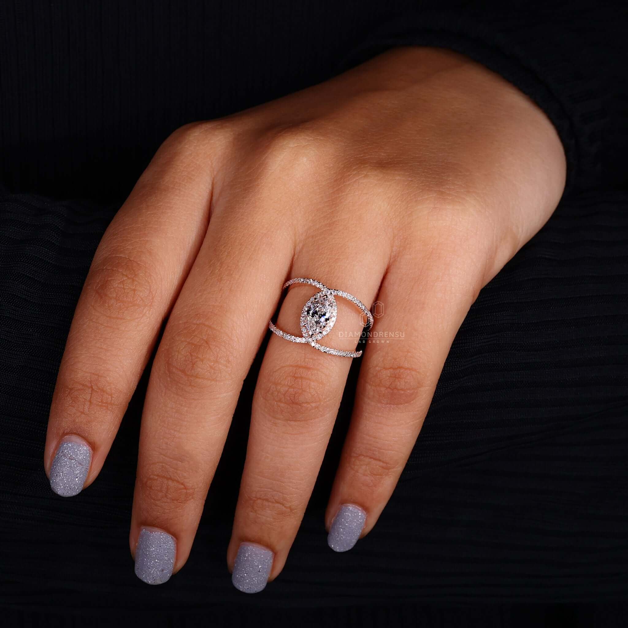 Marquise diamond ring with a pave ring design, perfect for modern elegance.