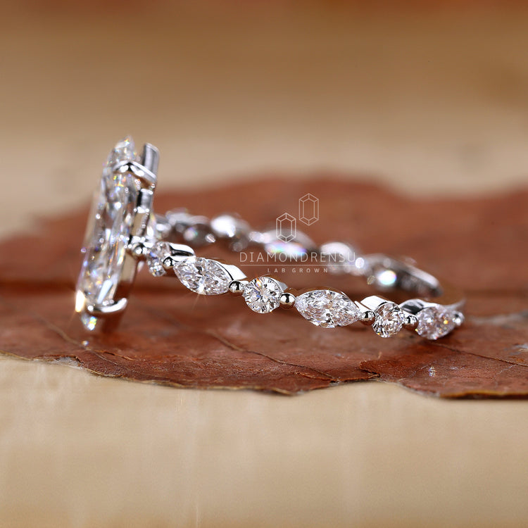 Round side stone engagement ring featuring lab grown diamond accents.
