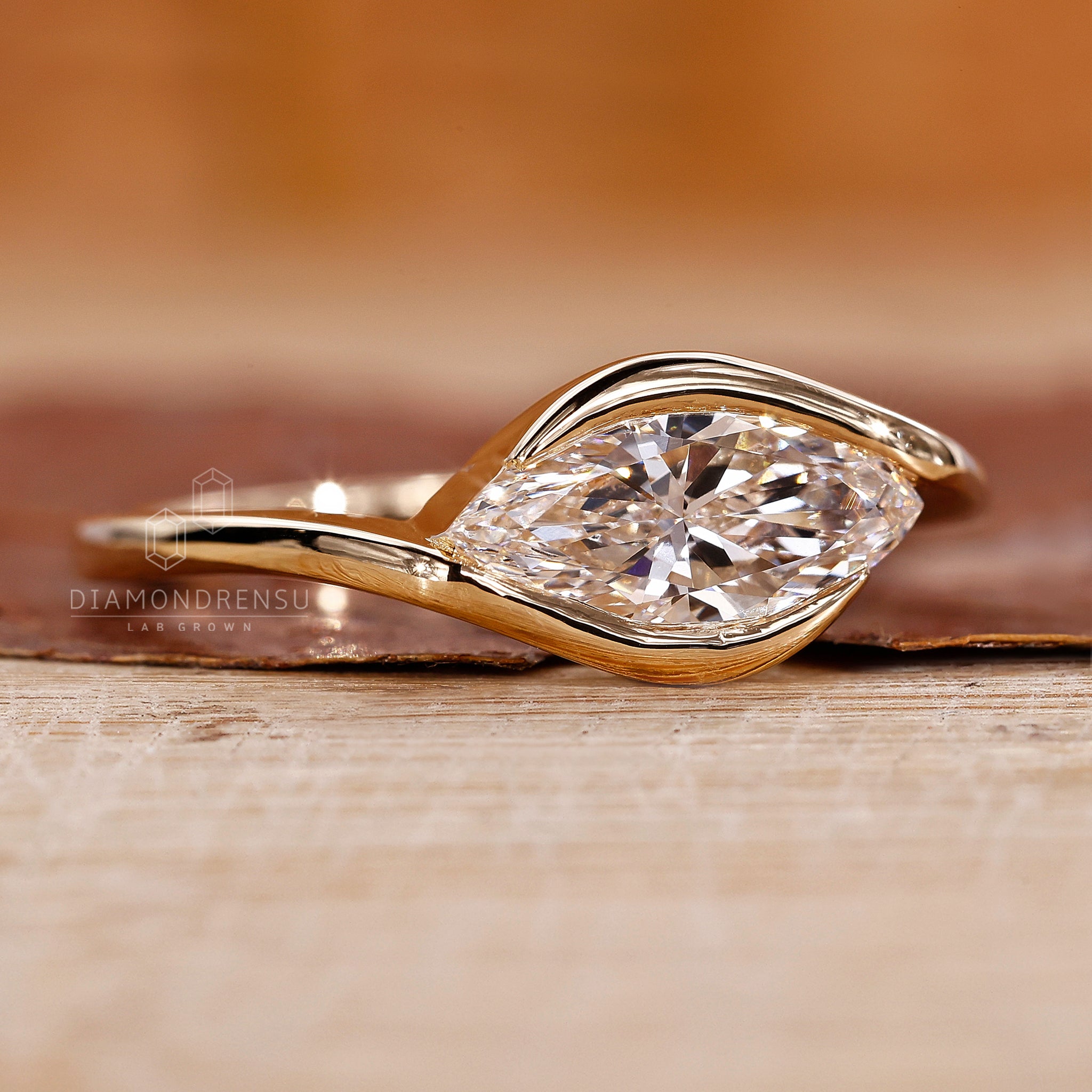Solitaire setting marquise diamond ring handmade in yellow gold.
