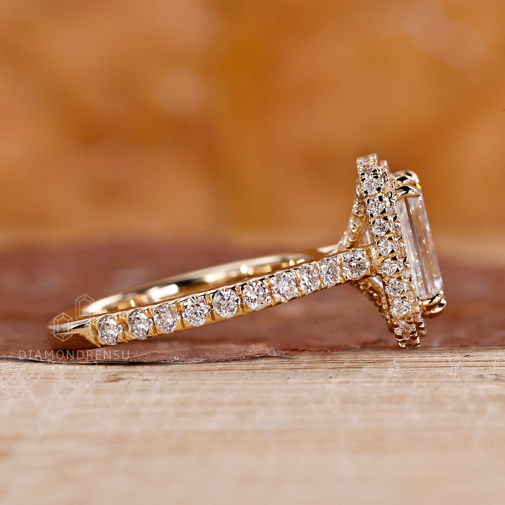 Unique engagement ring includes emerald design with detailed accents.

