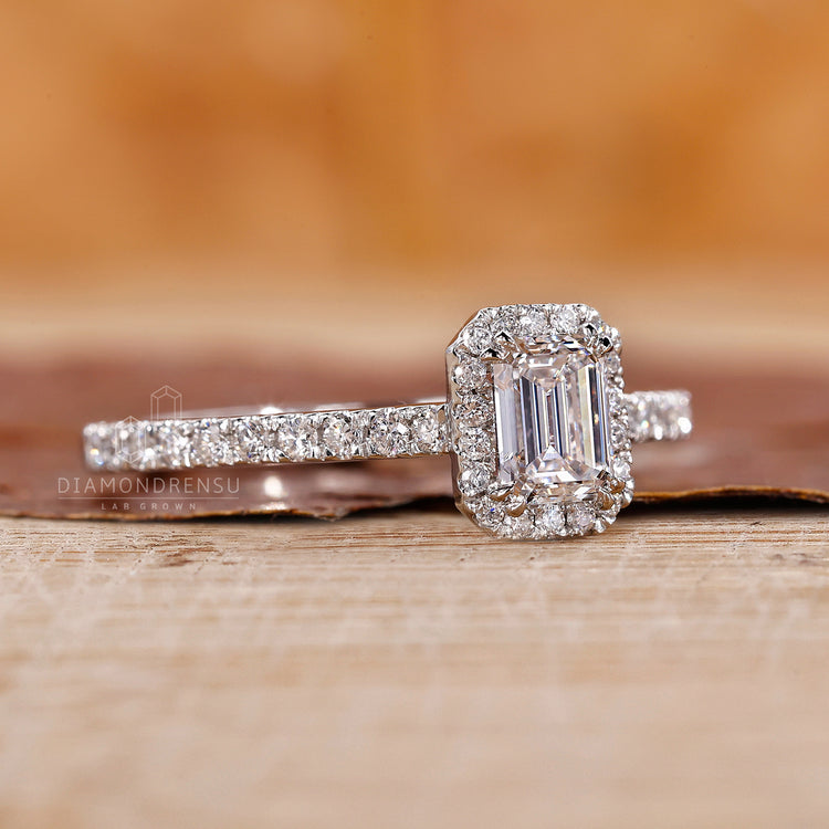 Double prong ring highlights the emerald center stone.
