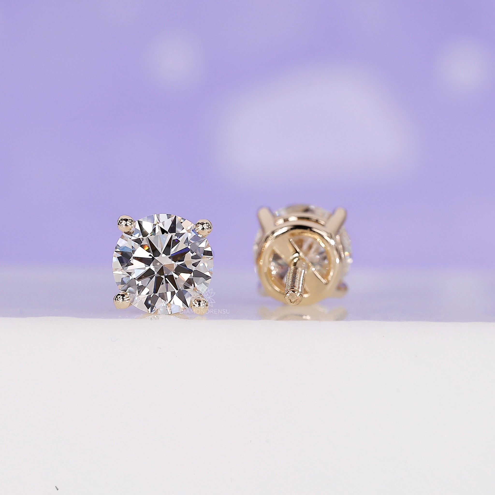 Handmade jewellery showcasing gold round diamond stud earrings.