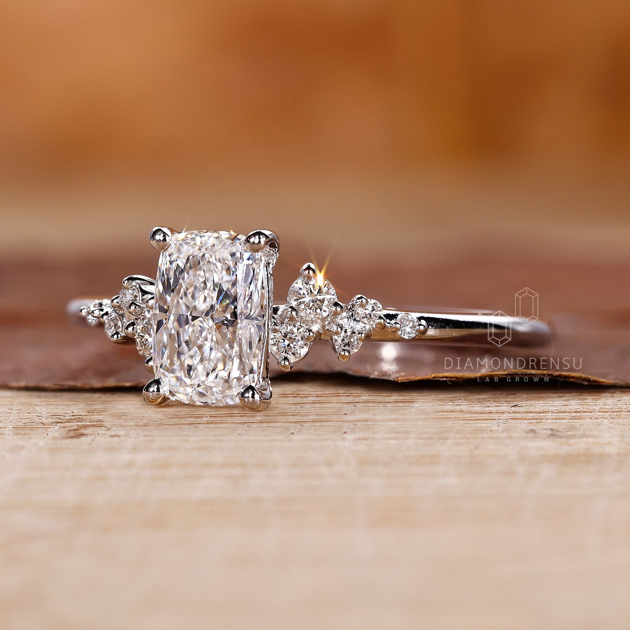 Buy engagement ring with cushion cut centre and round accents.

